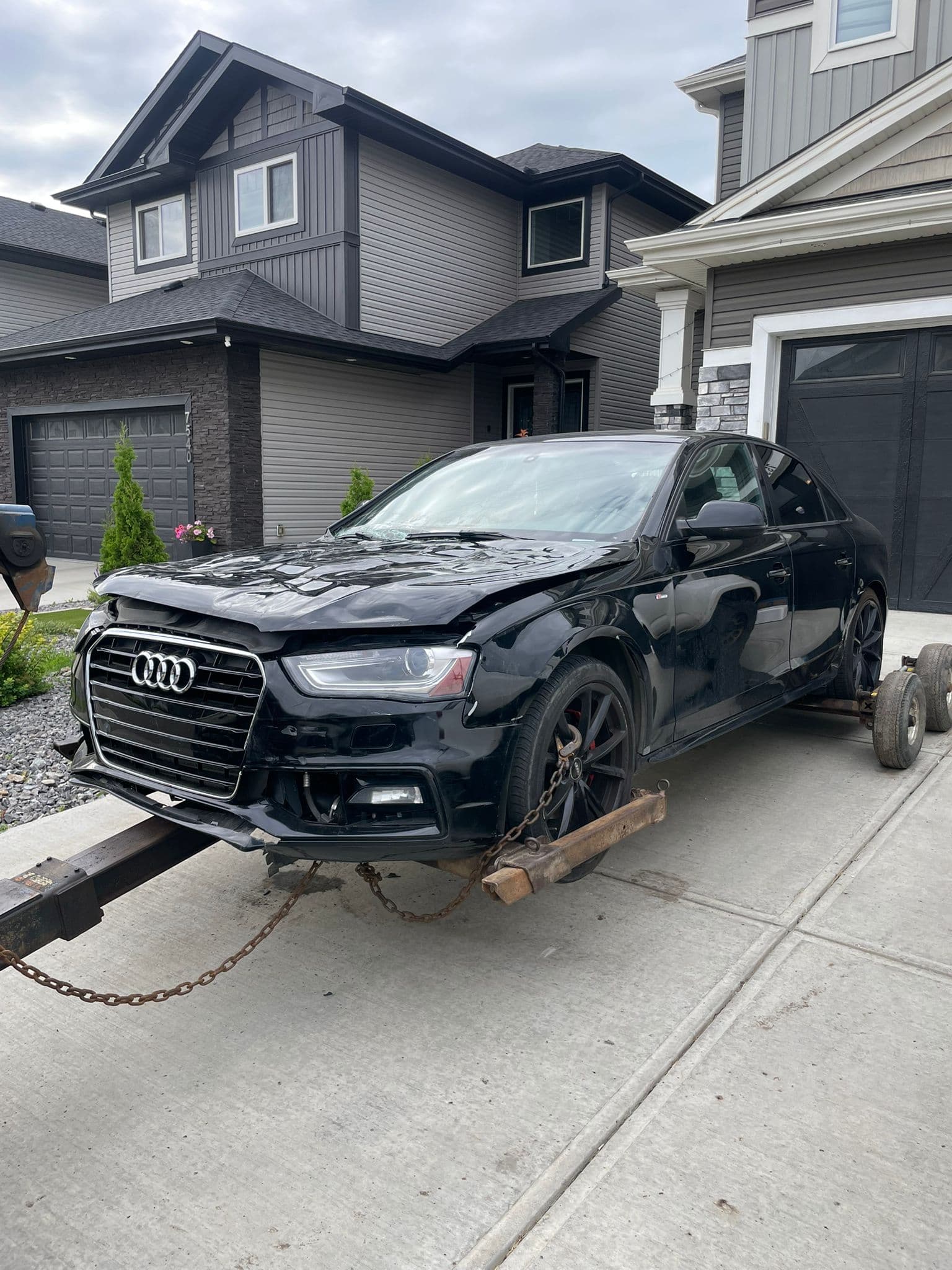 Damaged black Audi on a tow truck in Edmonton